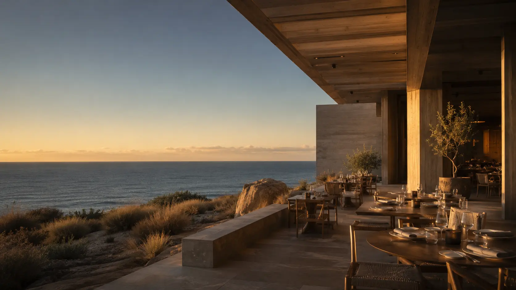 Coastal restaurant terrace overlooking the ocean at golden hour